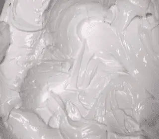 Close-up of AMEX low bleed white plastisol ink for screen printing, showcasing its opaque and smooth texture.