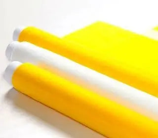 Rolls of yellow mesh screen printing supplies for high-quality designs.