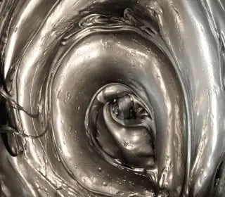 Close-up of metallic silver plastisol ink, showcasing its smooth, glossy texture for screen printing applications.