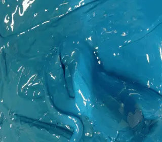 Close-up of vibrant neon blue plastisol ink, perfect for screen printing on various fabrics.